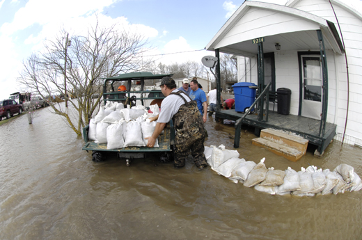 A wall of sandbags around a house in Arkansas that volunteers are trying to fortify as floodwaters breach it.