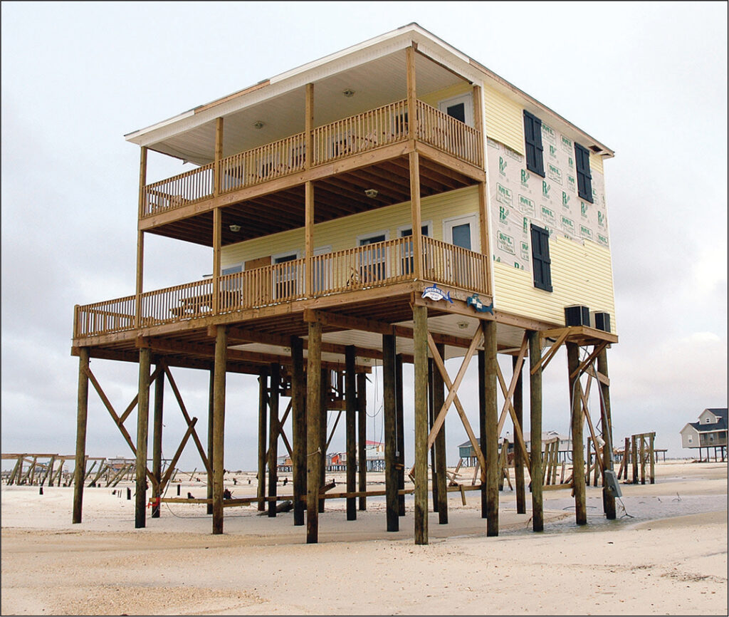 Example of a well-elevated and embedded pile foundation, with adjacent building failures visible.
