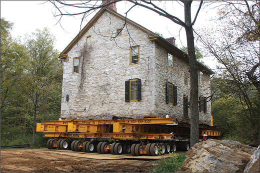 A stone house on a trailer.