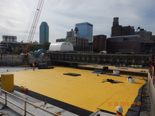 A shot from above showing the installation of a waterproof membrane and Dilatec strips over a slab.