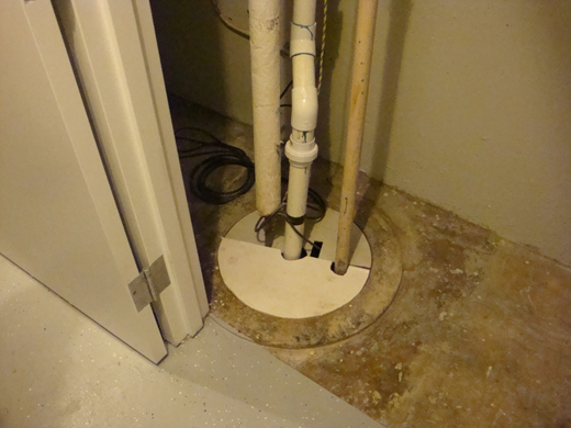 Sump and sump pump covered by sump cover.