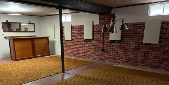 The photos only show the covers over the deadman anchors to the interior of the brick basement wall.