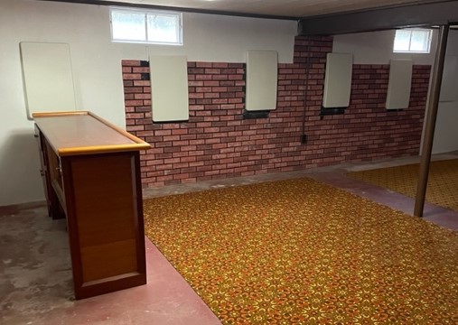 The photos only show the covers over the deadman anchors to the interior of the brick basement wall.